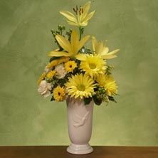 Vase arrangement with sunny Gerbera daisies and ye