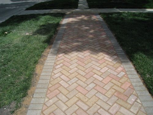 Custom herringbone walk way to porch.
