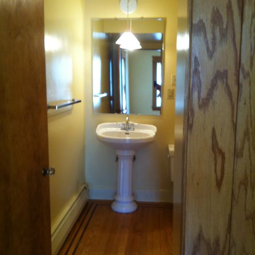 A Bathroom with a dual feature strip border.
