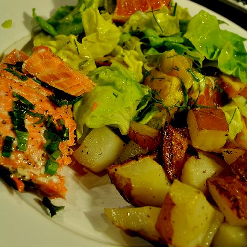 Wild salmon with roasted garlic potatoes and a sal
