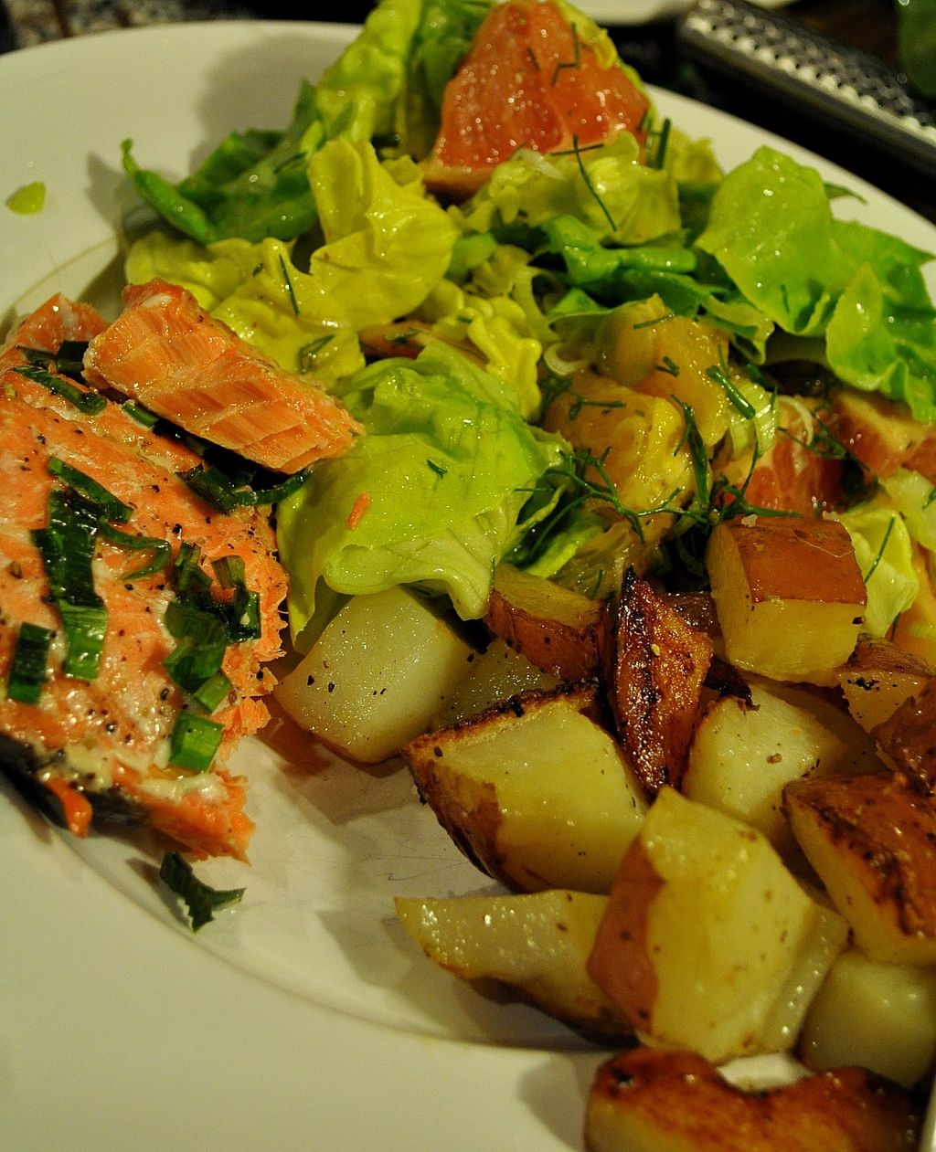Wild salmon with roasted garlic potatoes and a sal