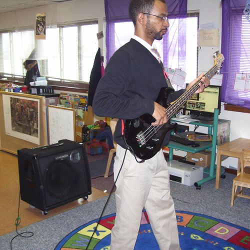 Introducing bass guitar to children's class.