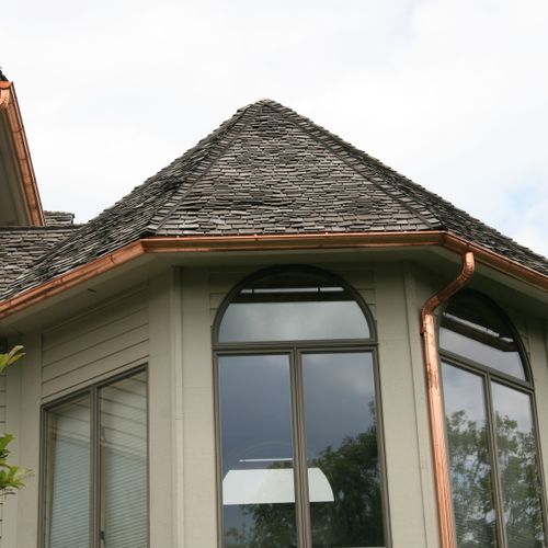 Copper half round gutters on a turret