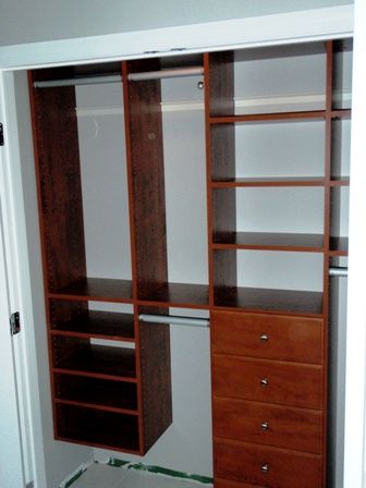 A tight reach-in closet has drawers, hanging, fold