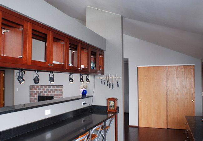 Suspended glass door cabinets connect the kitchen 