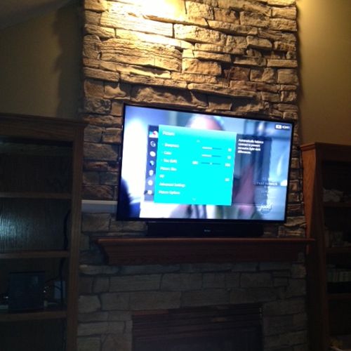 60 inch Led Tv over stone fireplace