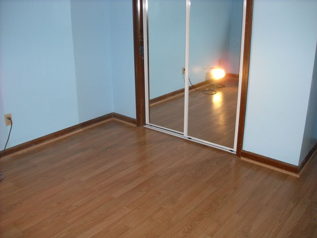 Installed laminate flooring and mirrored slider.