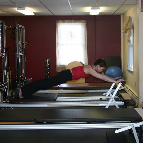 Co-Owner on reformer, performing long stretch