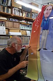 Heating vinyl wrap to conform to contours.