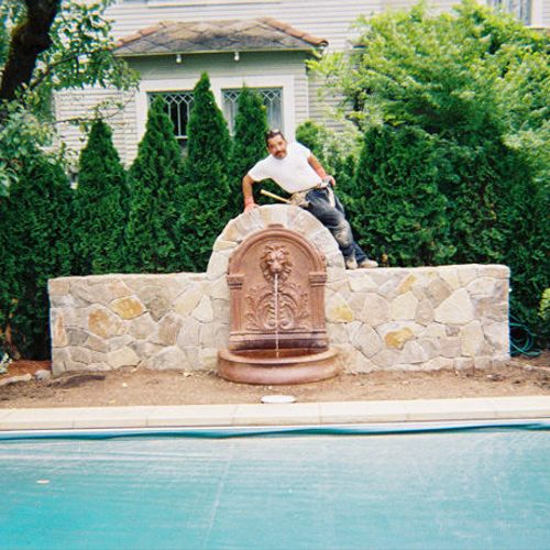 Custom made  Lion Fountain near a pool.