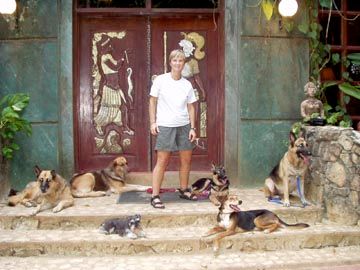 Beverly with a pack of dogs she trained in Belize