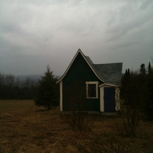 teeny little house in gray sky
