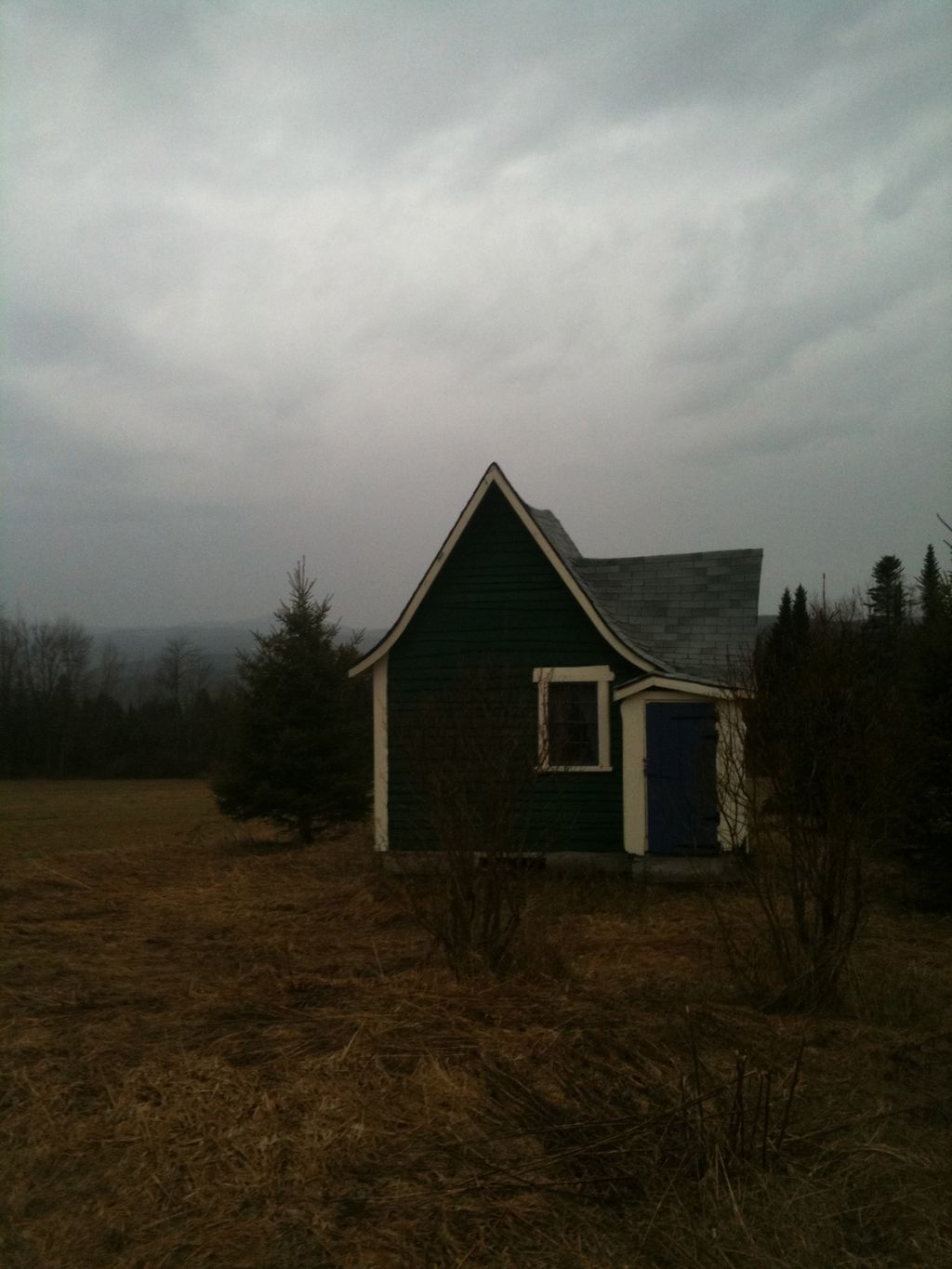 teeny little house in gray sky