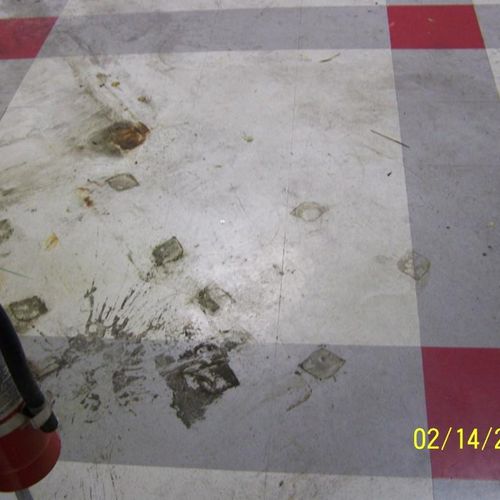 Tile floor in manufacturing building, before
