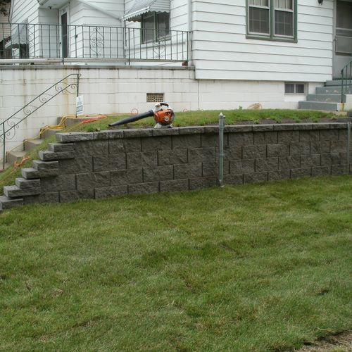 Longer block retaining wall to replace older wall