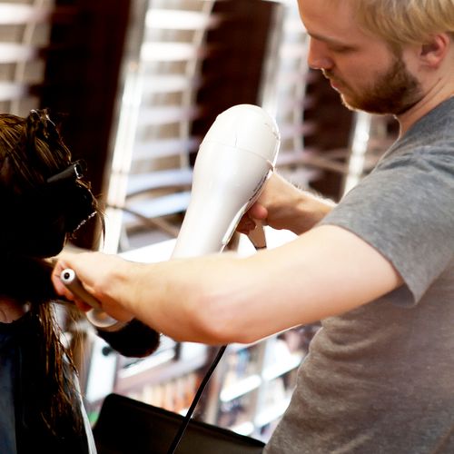One of our stylists, Chad, blow-drying a client!