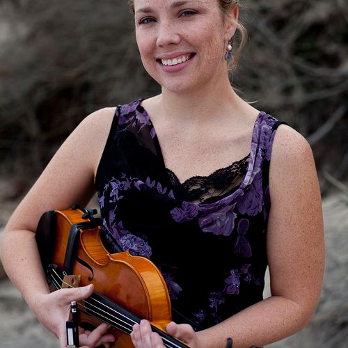 Christine Young, violinist performing at an ocean 