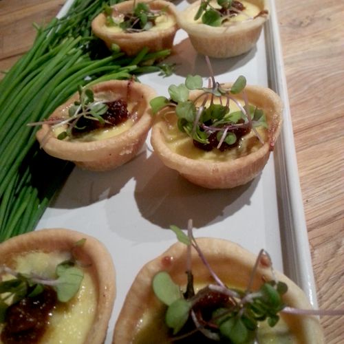 Caramelized onion tartlet finished with crumbled b