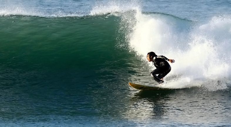 Overhead winter swell hitting sunset.