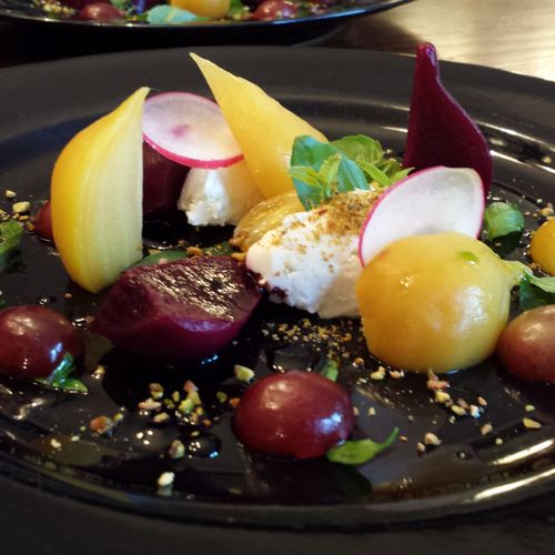 Baby beet salad with goat cheese, red grapes, radi