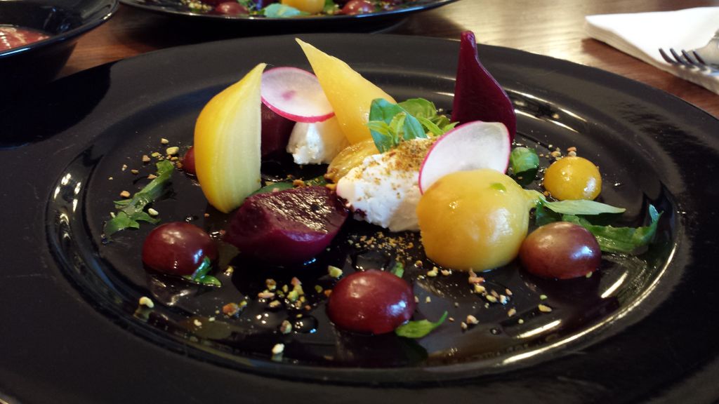 Baby beet salad with goat cheese, red grapes, radi