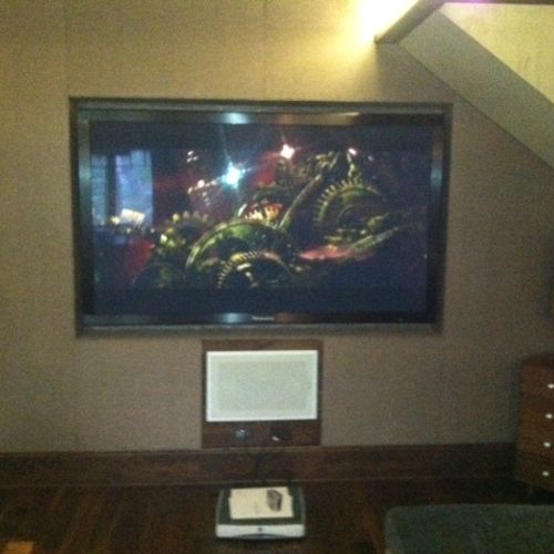 85" TV recessed into an acoustically treated wall.