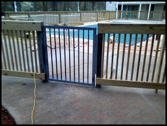 Wood fence around pool with a welded metal fabrica