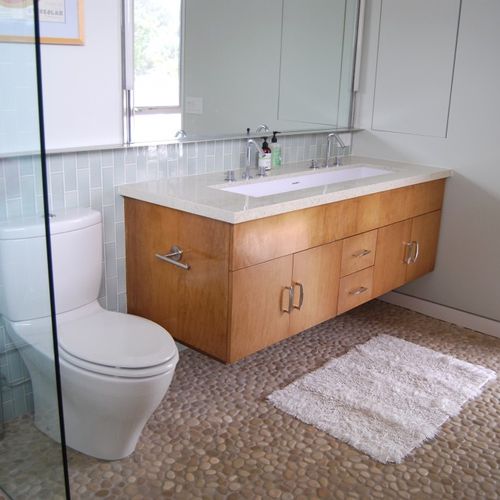 Remodeled bathroom with custom vanity and trough s