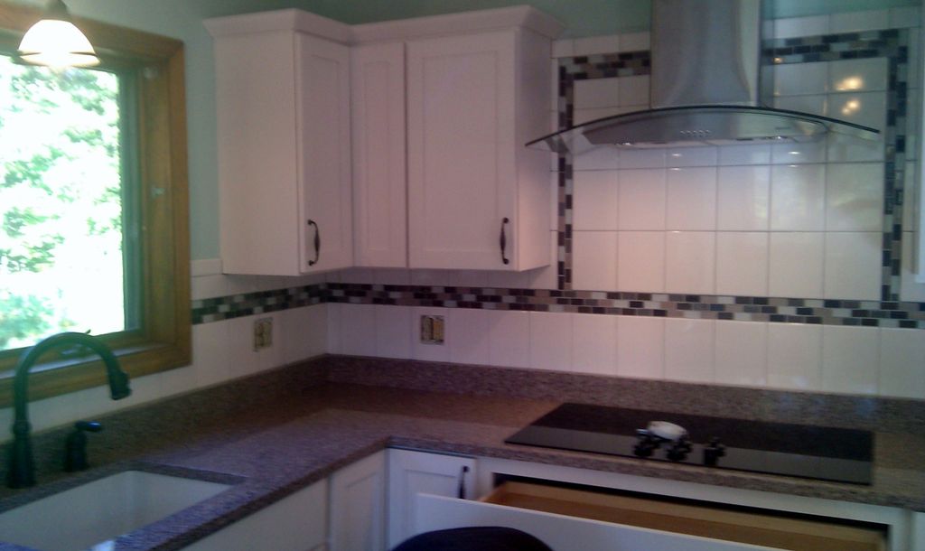new cabinets, tile backsplash, range hood, granite