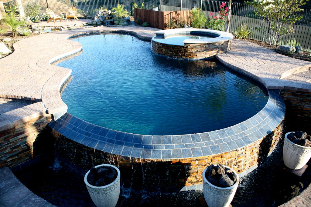 Infinity edge pool with stacked stone and fire pot