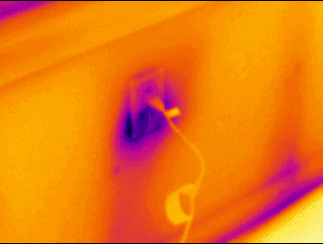 Infrared image of an exterior wall outlet losing h