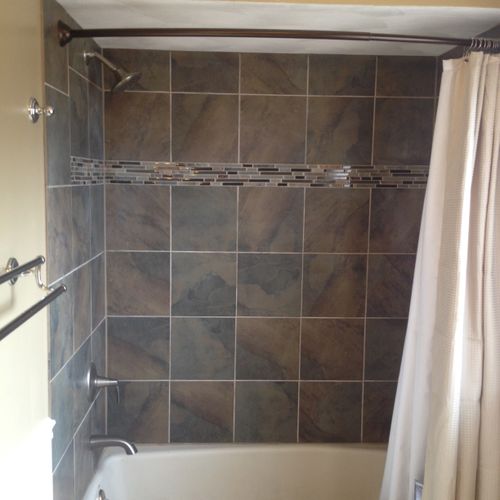 A new tile surround, paint, shower rod and plumbin