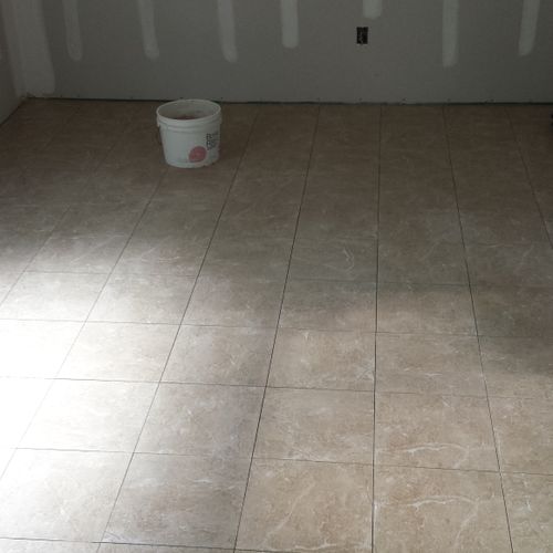 Rectified tile laid with penny size grout joints.