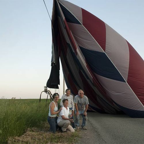 Passengers and the balloon pilot pose after an unu
