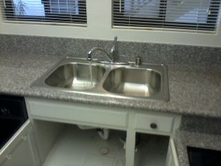 Replaced a kitchen sink, plumbing, faucet and garb