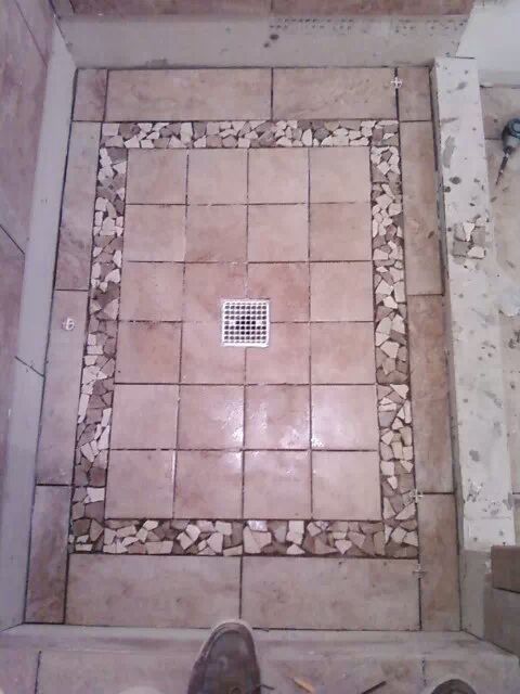 Shower floor with stone border