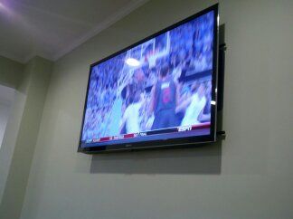 55" TV mounted with tilt mount in sitting area