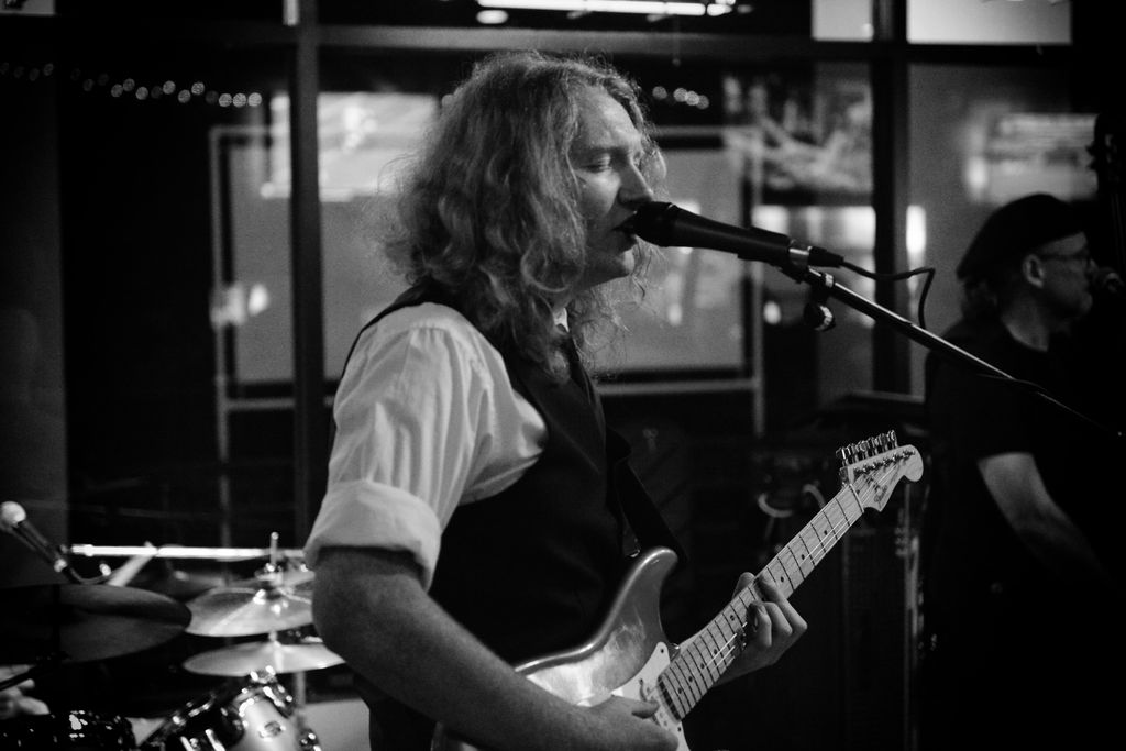 B/W photo of live performance. 