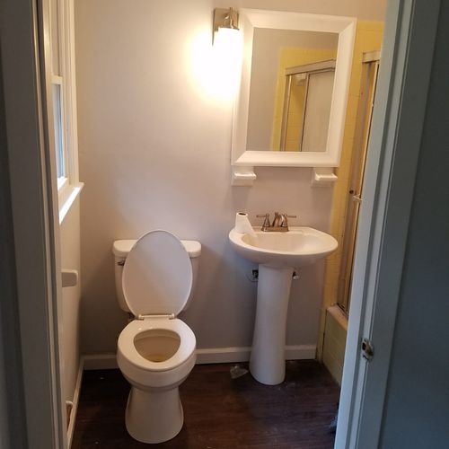 New floor, toilet, vanity, mirror, light installed