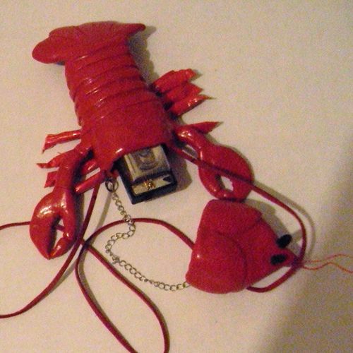 Lobster shaped wearable harmonica case.  Polymer c