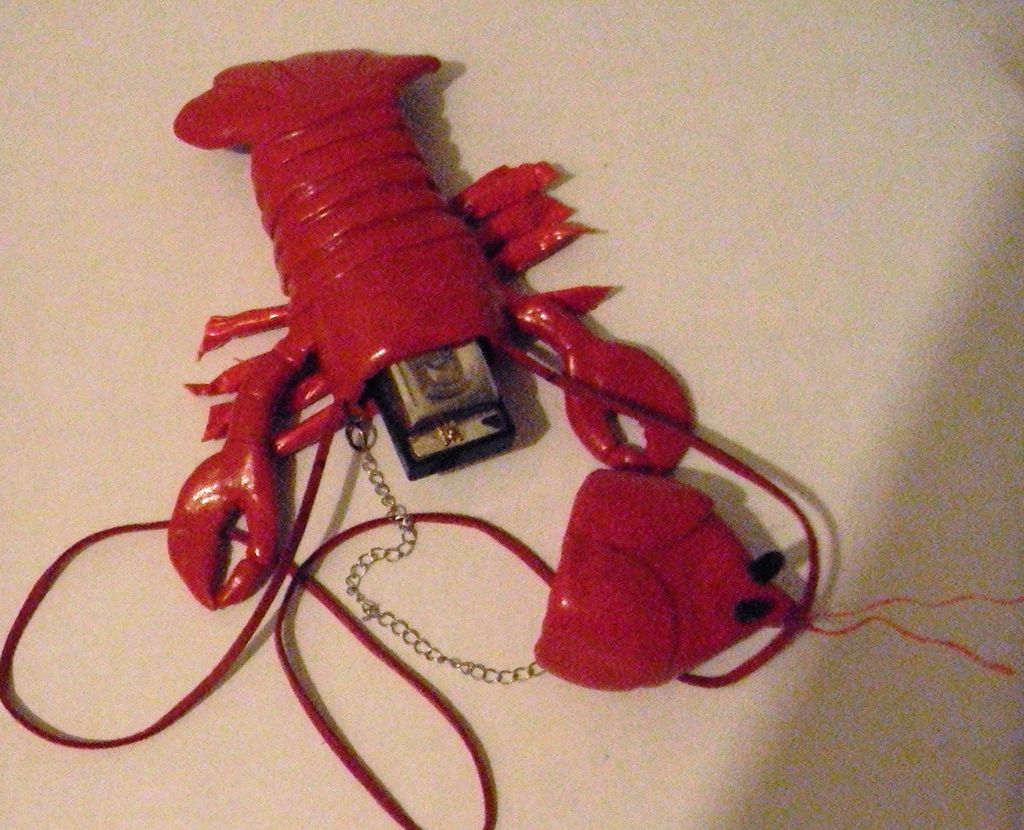Lobster shaped wearable harmonica case.  Polymer c