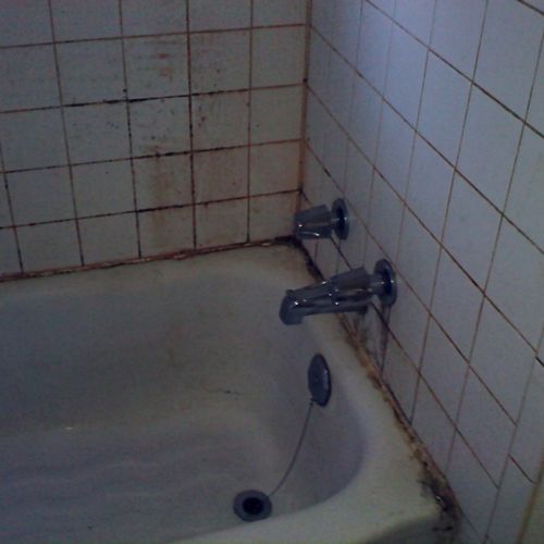 Uncleaned residential bathroom wall and tub #2