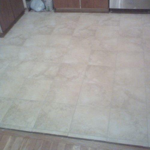 Ceramic tiles installed in small kitchen.