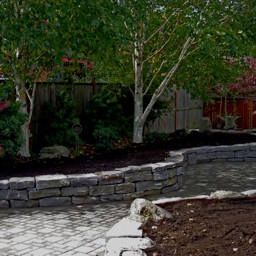 Curving paver path and natural stone reatinign wal