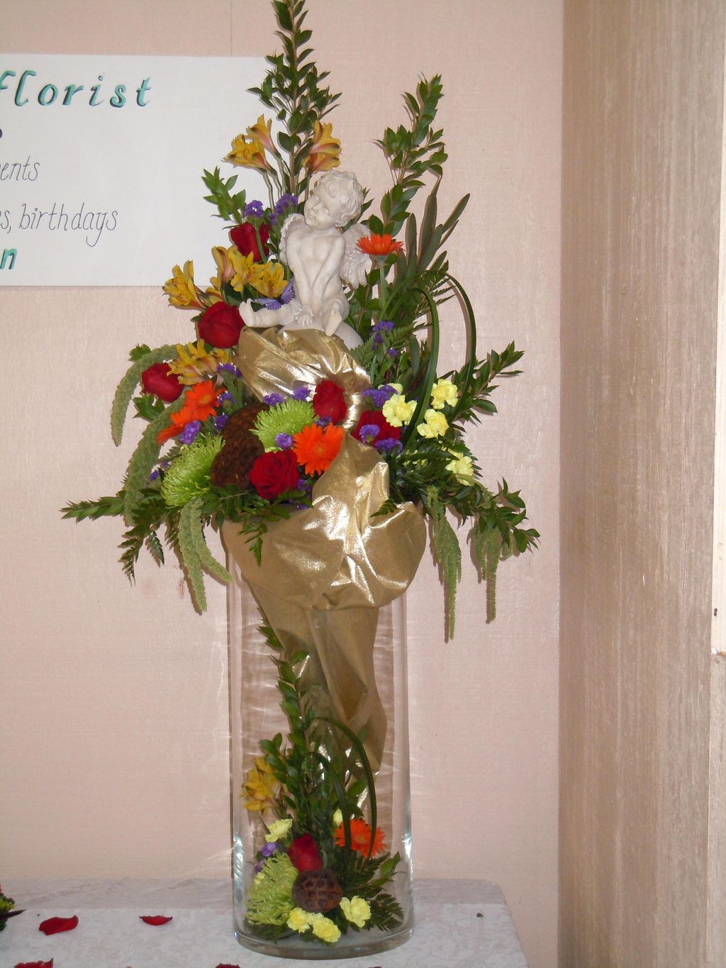 Cherub in an arrangement of lilly grass, alstromer