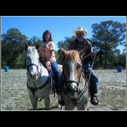 A couple of ranch owners enjoyiing a ride.