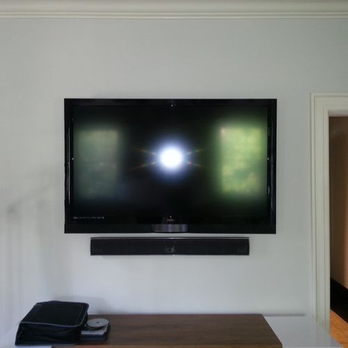60 inch Flat Panel mounted above dresser with Surr