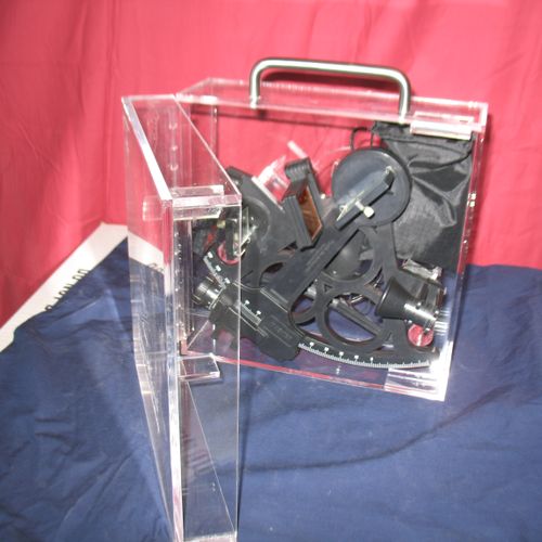 An acrylic case for a sextant.