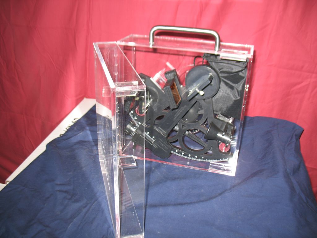 An acrylic case for a sextant.