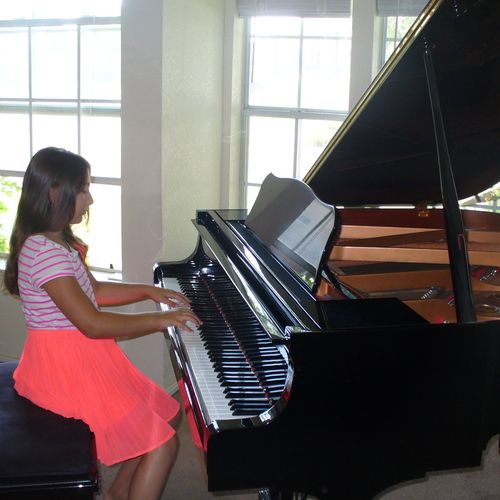 A student enjoying the piano.